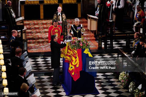 Members of the Royal Family watch as the Imperial State Crown is removed from the coffin of Queen Elizabeth II during the Committal Service at St...