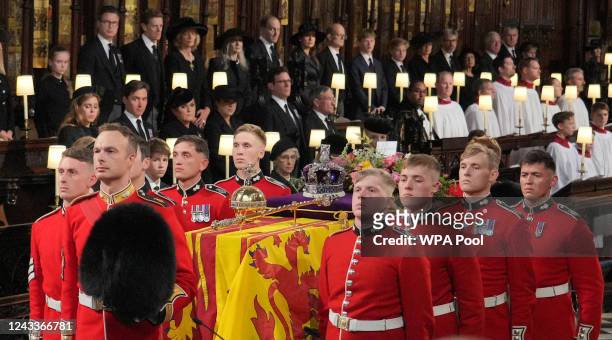 The coffin of Queen Elizabeth II is carried by Pall bearers from the Queen's Company, 1st Battalion Grenadier Guards during the Committal Service for...