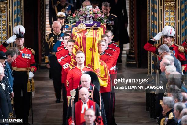 The Bearer Party of The Queen's Company, 1st Battalion Grenadier Guards carry the coffin of Queen Elizabeth II, draped in a Royal Standard and...