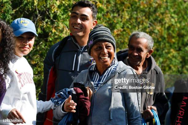 Martha's Vineyard, MA A Venezuelan migrant gathers outside of St. Andrew's Parish House to board a bus to the Vineyard Haven ferry terminal. Two...