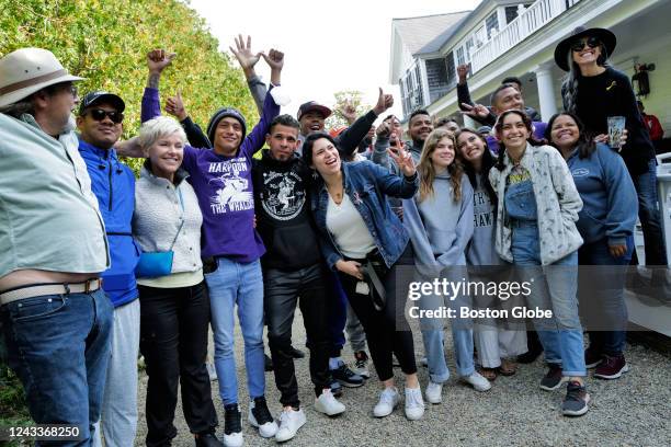 Martha's Vineyard, MA Venezuelan migrants and volunteers celebrate together outside of St. Andrew's Parish House. Two planes of migrants from...