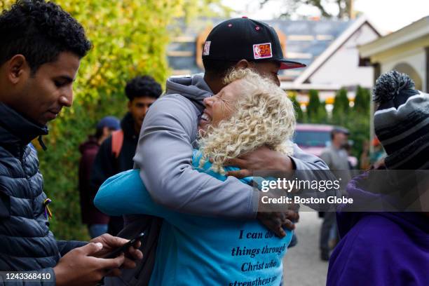 Martha's Vineyard, MA Lisa Belcastro, a volunteer, embraces Rafael, a Venezuelan migrant, outside of St. Andrew's Parish House. Two planes of...