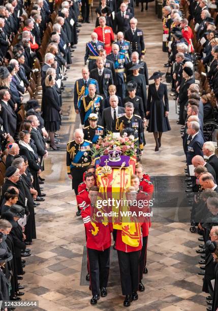 King Charles III and members of the royal family follow behind the coffin of Queen Elizabeth II, draped in the Royal Standard with the Imperial State...