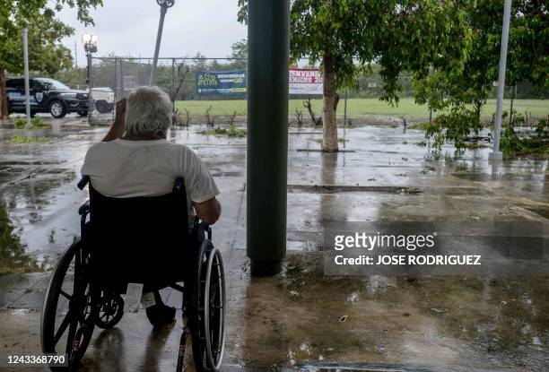 Man in Wheelchair looks at a flooded road after the passage of hurricane Fiona in Salinas, Puerto Rico, on September 19, 2022. - Hurricane Fiona...