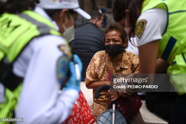 Woman receives medical care after an earthquake in Mexico City on September 19, 2022. 8-magnitude earthquake struck western Mexico on Monday, shaking...