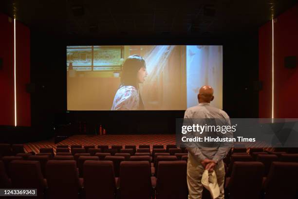 Vikas Dhar son of the owner of 'INOX' multiplex Vijay Dhar watches a trailer of a Bollywood movie ahead of the inauguration of the multiplex...