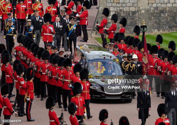 Prince William, King Charles III, Princess Anne, Prince Harry, Prince Andrew and Prince Edward follow the hearse carrying the coffin of Queen...