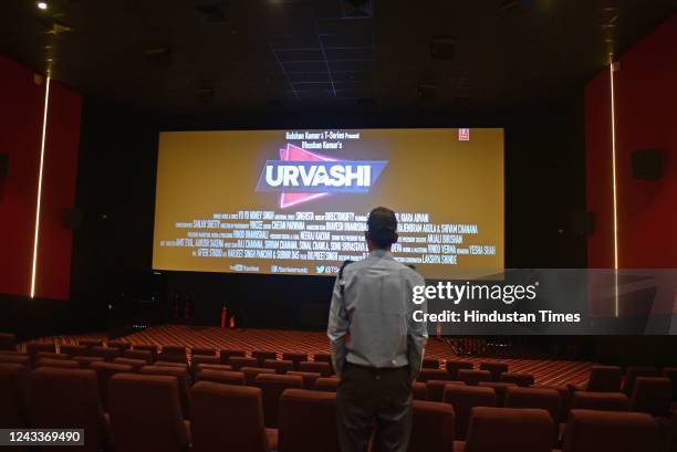 Secuirty guard watches a trailer of a Bollywood movie ahead of the inauguration of the multiplex comprising three cinema auditoriums with a capacity...