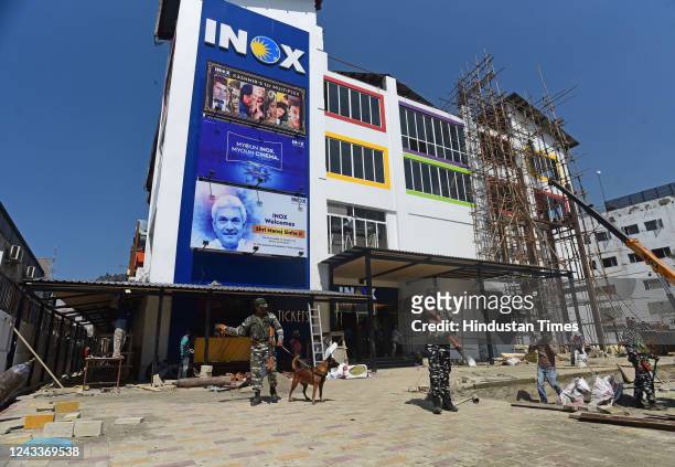 Security forces stand guard at 'INOX' multiplex ahead of the inauguration of the multiplex comprising three cinema auditoriums with a capacity of 520...