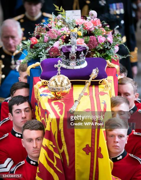 King Charles III and members of the royal family follow behind the coffin of Queen Elizabeth II, draped in the Royal Standard with the Imperial State...