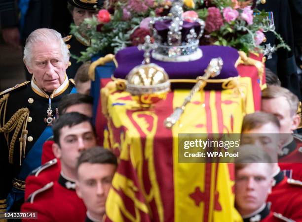 King Charles III and members of the royal family follow behind the coffin of Queen Elizabeth II, draped in the Royal Standard with the Imperial State...