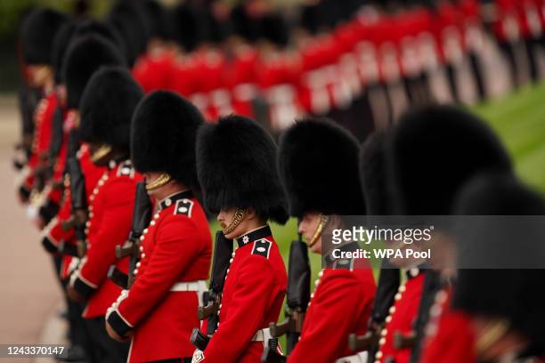 Soldiers from the Grenadier Guards line the route of the State Hearse as it carries the coffin of Queen Elizabeth II, draped in the Royal Standard...