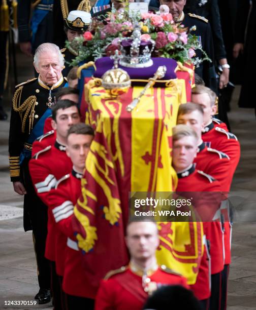 King Charles III and members of the royal family follow behind the coffin of Queen Elizabeth II, draped in the Royal Standard with the Imperial State...