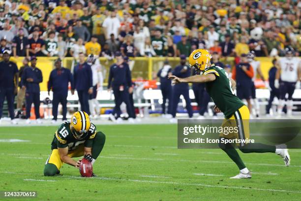 Green Bay Packers place kicker Mason Crosby kicks from the hold of Green Bay Packers punter Pat O'Donnell during a game between the Green Bay Packers...