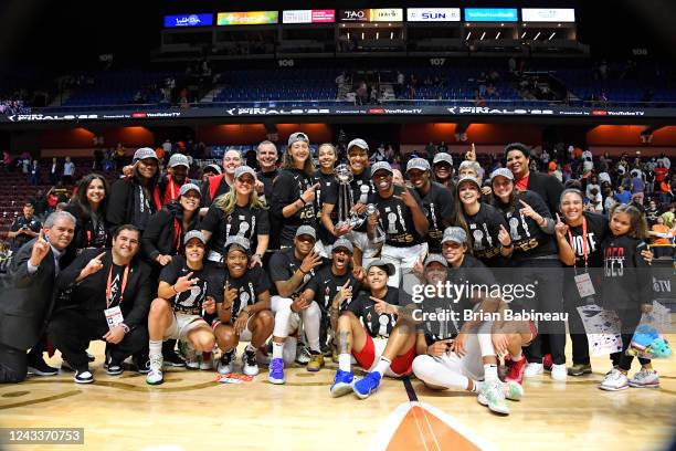 The Las Vegas Aces pose for a photo with the 2022 WNBA Finals championship trophy after the win against the Connecticut Sun in Game 4 of the 2022...