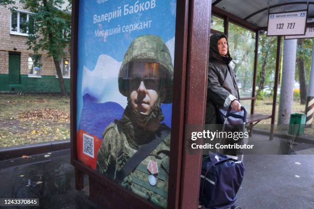 Poster with portrait of Russian lance sergeant Valery Babkov, awarded this year with the Medal of Suvorov for his participation in the war against...