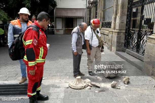 Civil protection personnel check the damage to the façade of the Nuestra Señora de la Merced church moments after an earthquake in Guadalajara,...