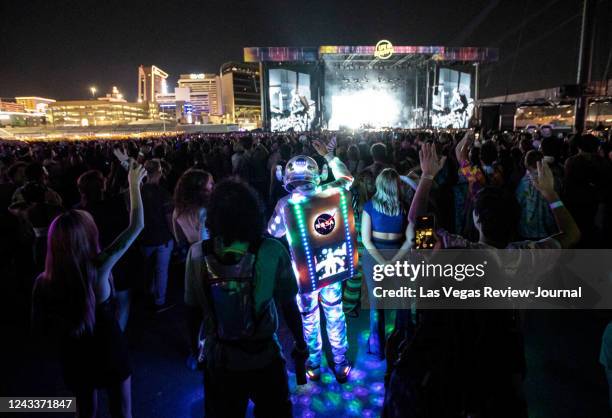 An attendee dressed up in a space suit cheers as Cage the Elephant performs during the first day of the Life is Beautiful festival on Friday, Sept....