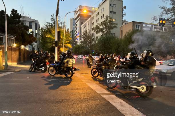 Picture obtained by AFP outside Iran shows shows Iranian police on motorbikes during a protest in support of Mahsa Amini, a woman who died after...