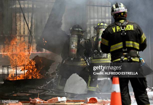 Fireghters take part in an earthquake drill at the Zocalo Square in Mexico City on September 19 as Mexico marks the anniversaries of the 1985 and...