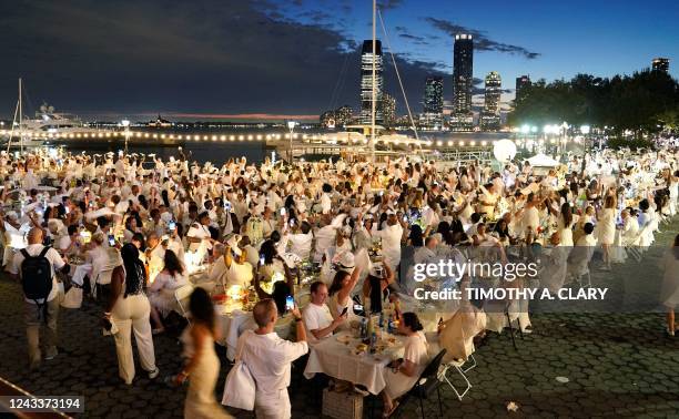 People attend the 10th edition of "Diner en Blanc" at Brookfield Place in Lower Manhattan September 19, 2022. - The legendary all-white secret...