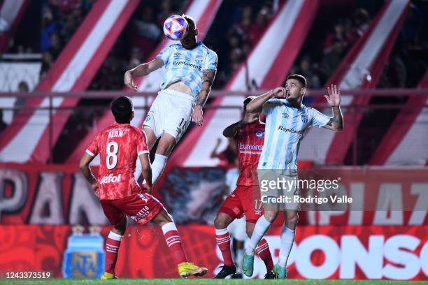 Cristian Menendez of Atletico Tucuman heads the ball against Alan Rodriguez of Argentinos during a match between Argentinos Juniors and Atletico...