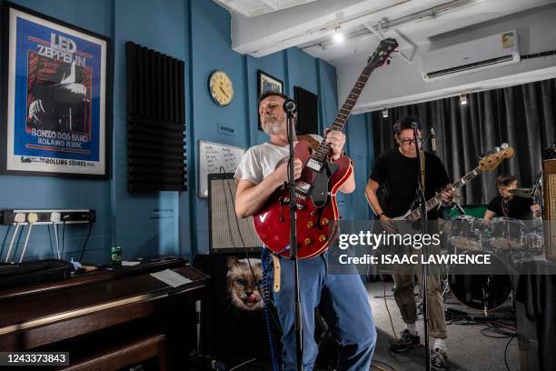 This picture taken on September 9, 2022 shows band members of The David Bowie Knives performing in a studio, for an audience watching a live stream...