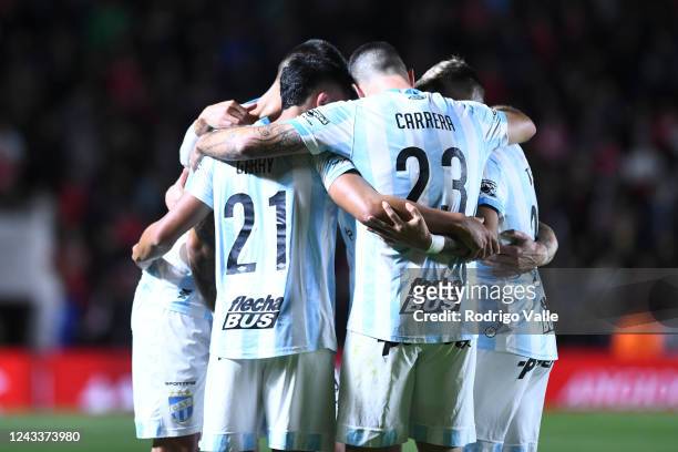 Cristian Menendez of Atletico Tucuman celebrates with teammates after scoring the first goal of his team during a match between Argentinos Juniors...