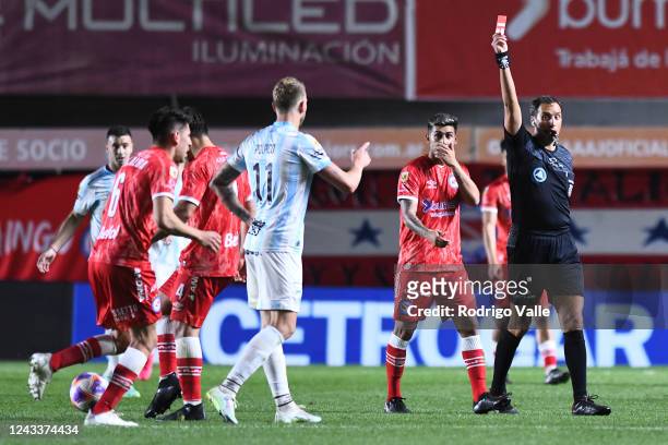 Referee Fernando Rapallini shows red card to Cristian Menendez of Atletico Tucuman during a match between Argentinos Juniors and Atletico Tucuman as...