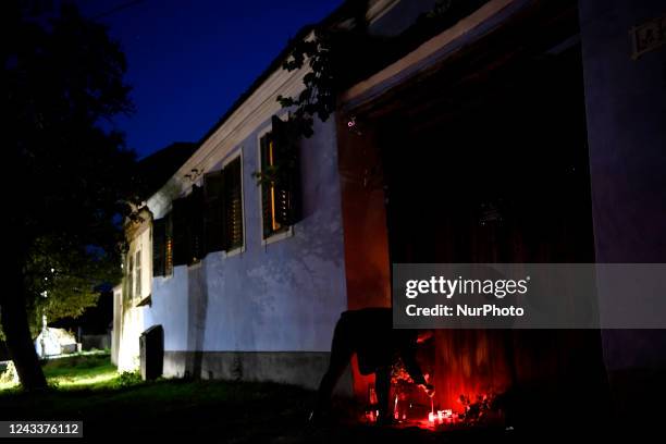 People light candles in front of the ''Blue House'' owned by the current sovereign King Charles III in Viscri, Brasov, Romania. British ambassador...