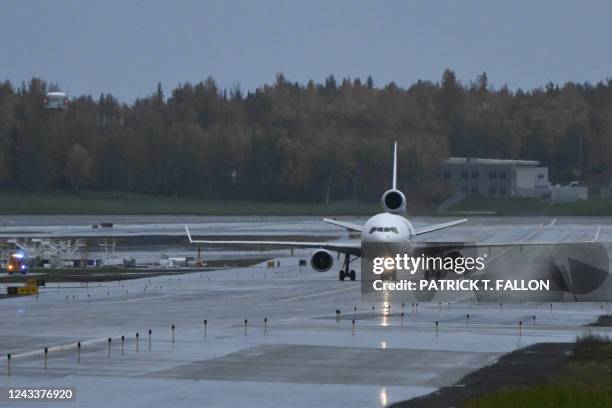FedEx Express McDonnell Douglas MD-11 cargo aircraft taxis in the rain after landing at the Ted Stevens International Airport TKTK in Anchorage,...