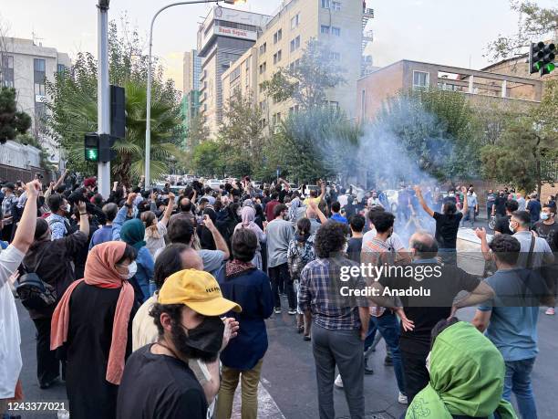 People gather during a protest for Mahsa Amini, who died after being arrested by morality police allegedly not complying with strict dress code in...