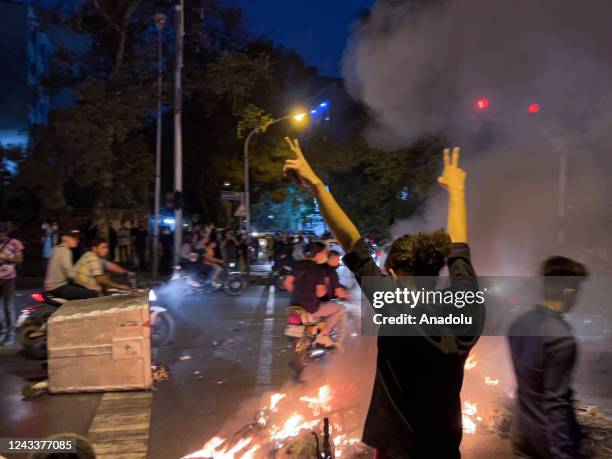 People gather during a protest for Mahsa Amini, who died after being arrested by morality police allegedly not complying with strict dress code in...