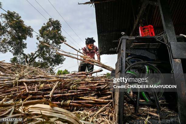 This photo taken on September 19, 2022 shows a worker processing sugar cane to produce brown sugar at a home industry in Ketol, central of Aceh...