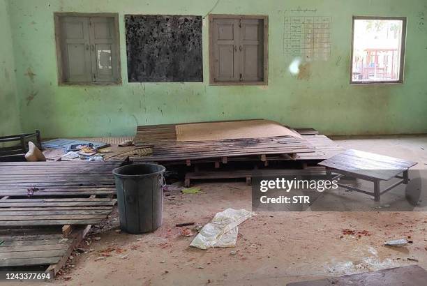 This photo taken on September 17, 2022 shows debris and bloodstains on the floor of a damaged school building in Depeyin township in Myanmar's...