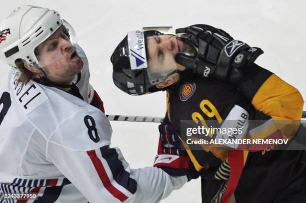 German Alexander Barta reacts to a stick hitting by US Philip Kessel during their qualifying round group F game of the IIHF International Ice Hockey...