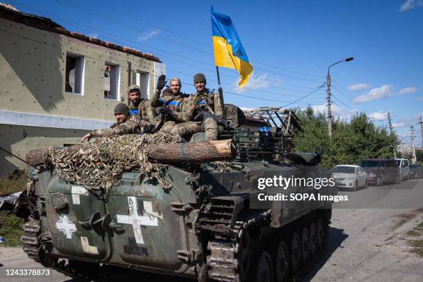 Ukrainian soldiers ride in an armored tank in the town of Izium, recently liberated by Ukrainian Armed Forces, in the Kharkiv region. Russian troops...