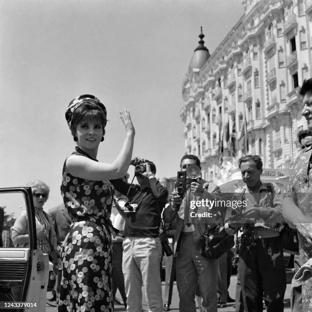 Italian actress Gina Lollobrigida waves to the crowd during the 18th Cannes Film Festival in Cannes, southern France on May 13, 1965.