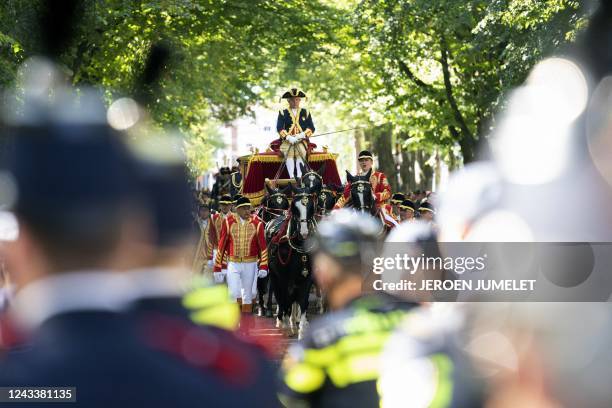 The Glass Carriage carrying the royal family rides towards the Royal Theater, known as Koninklijke Schouwburg, during the Prince Day in The Hague on...
