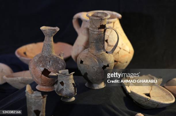 This picture taken on September 20, 2022 shows some of vessels that are believed to have contained opium in the 14th century BC, found at the Tel...