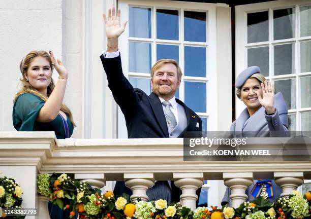 Princess Amalia, King Willem-Alexander and Queen Maxima wave on the balcony of the Noordeinde Palace in The Hague, on September 20, 2022. The new...