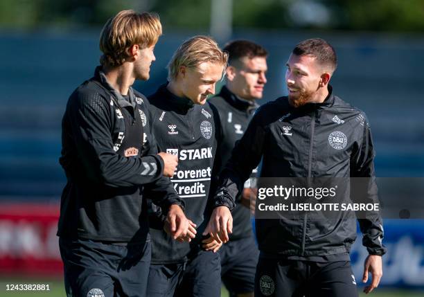 Denmark's defender Joachim Andersen, Denmark's forward Kasper Dolberg and Denmark's midfielder Pierre Hojbjerg chat during a training session in...