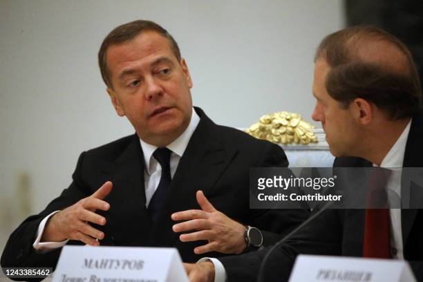 Russian Security Council Deputy Chairman and former President Dmitry Medvedev talks to Deputy Prime Minister Denis Manturov during a meeting on the...