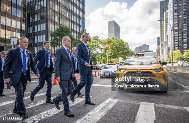 September 2022, US, New York: German Chancellor Olaf Scholz , accompanied by government spokesman Steffen Hebestreit and bodyguards, walks through...