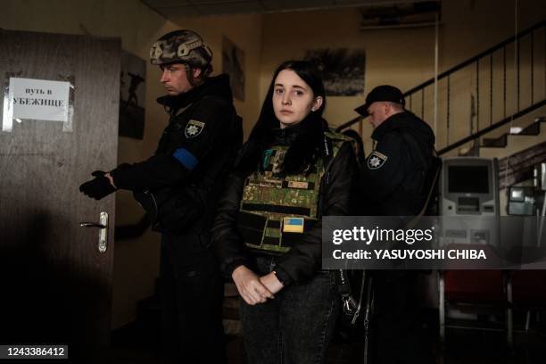 Woman waits to be evacuated with her parents, at the local civil administration office in the retaken town of Kozacha Lopan, Kharkiv region, on...