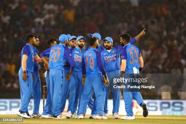 Rohit Sharma of India with team-mates wait for a DRS review during game one of the T20 International series between India and Australia at Punjab...