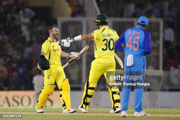 Matthew Wade and Pat Cummins of Australia celebrate the victory during game one of the T20 International series between India and Australia at Punjab...