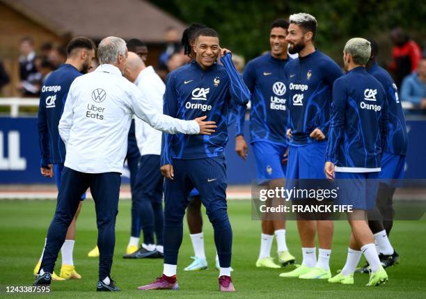 France's forward Kylian Mbappe smiles during a training session in Clairefontaine-en-Yvelines on September 20, 2022 as part of the team's preparation...