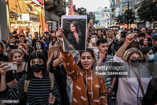 Protester holds a portrait of Mahsa Amini during a demonstration in support of Amini, a young Iranian woman who died after being arrested in Tehran...