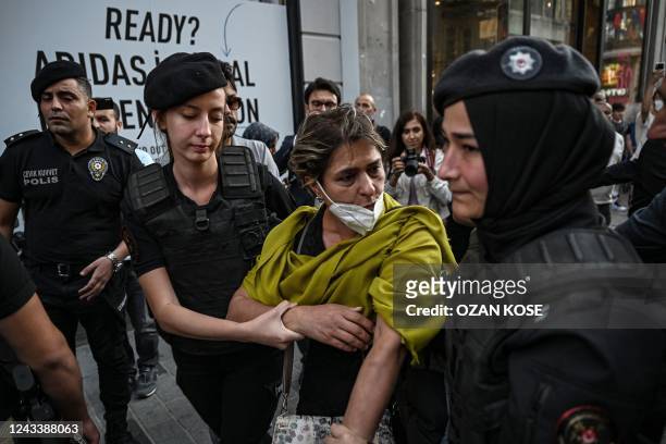 Turkish tiot police officers detain a protester during demonstration in support of Mahsa Amini, a young Iranian woman who died after being arrested...